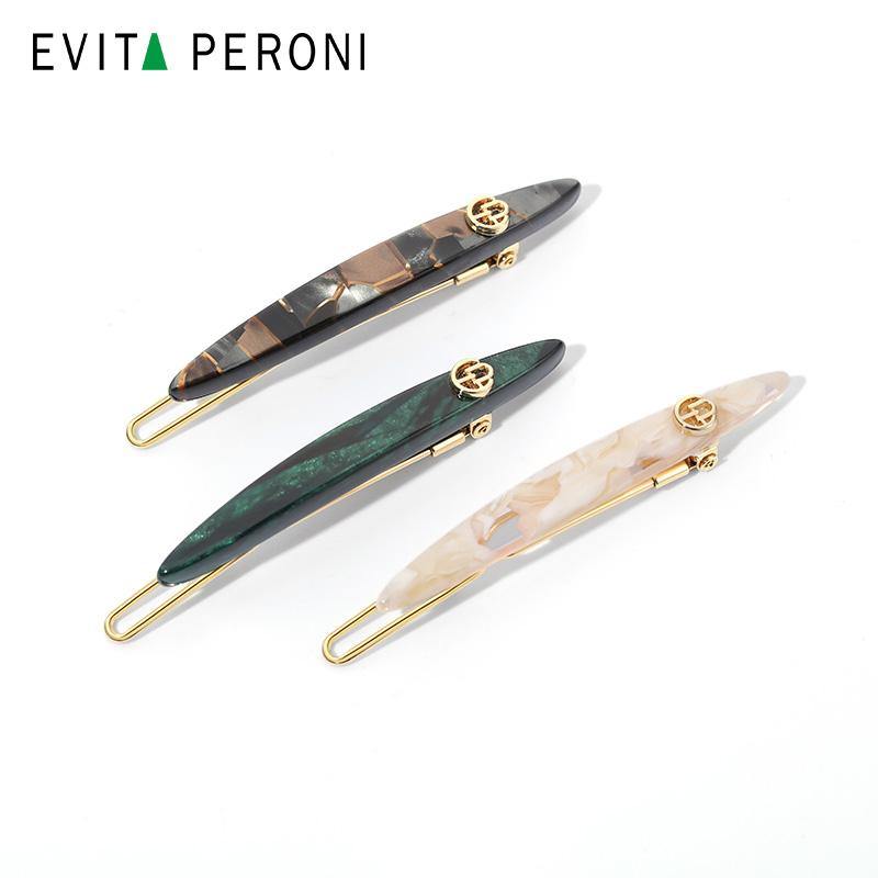 Set of three marbled hair barrettes with gold accents in black, green, and cream colors on white background.